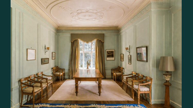 Room of furniture, carpet and high ceiling