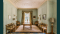 Room of furniture, carpet and high ceiling