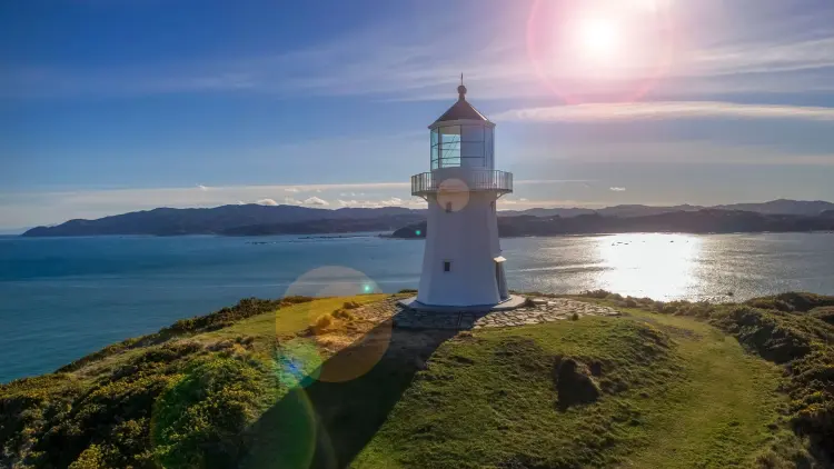 Photograph of a white lighthouse on a sunny day