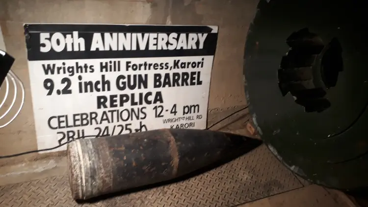 Large shell on ground next to "50th Anniversary" sign