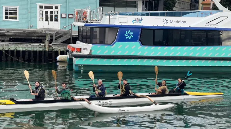 Six people in a waka on the water