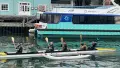 Six people in a waka on the water