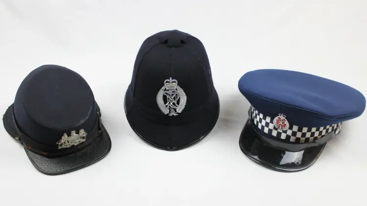 Three Police hats, ranging from different eras of history