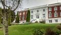 Exterior shot of white and red brick Philosophy House
