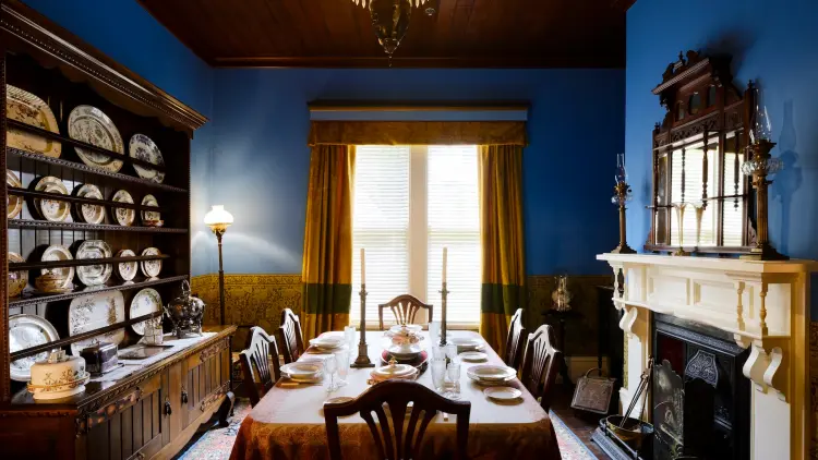 Dining room with blue wallpaper and a table