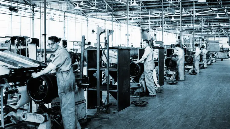 Black and white photograph showing 5 Dunlop factory workers using machinery