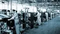 Black and white photograph showing 5 Dunlop factory workers using machinery