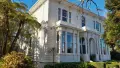 White colonial house surrounded by trees