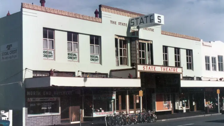 Pale teal building from a street view