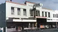 Pale teal building from a street view