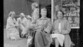 Vintage photo of 5 women sitting outside a store