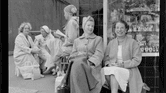 Vintage photo of 5 women sitting outside a store