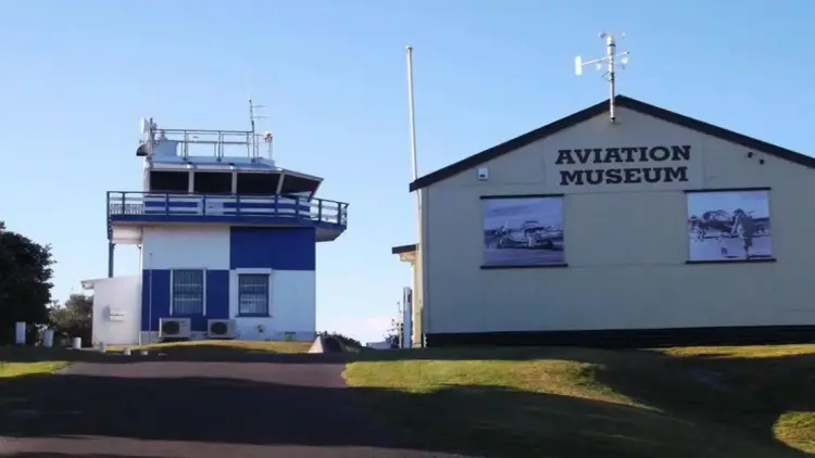 An exterior photo of the Kāpiti Coast Aviation Museum building, and the nearby tower