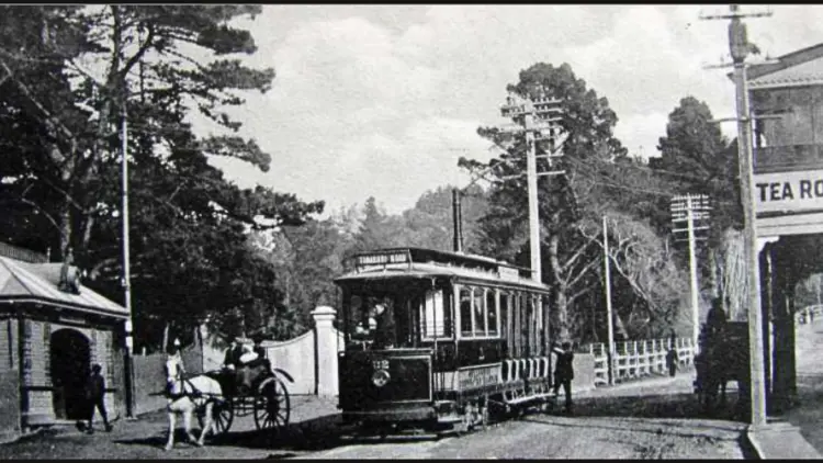 Black and white photo of a tramway and carriage pulled by a horse