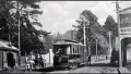 Black and white photo of a tramway and carriage pulled by a horse