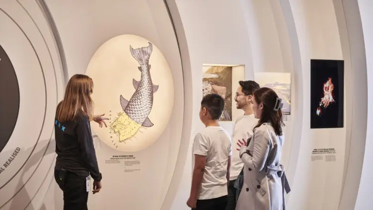 People standing in front of a museum display