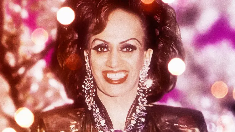 Transgender woman and drag queen Carmen Rupe in front of sparkly backgound