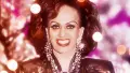 Transgender woman and drag queen Carmen Rupe in front of sparkly backgound