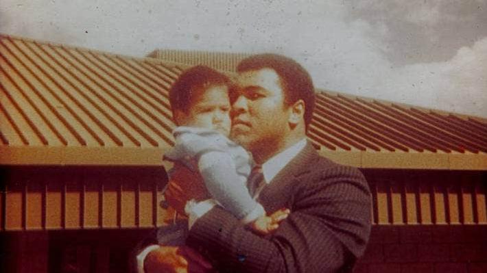 Muhammad Ali holding a young child