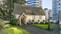 House with concrete pathway to door and green lawn