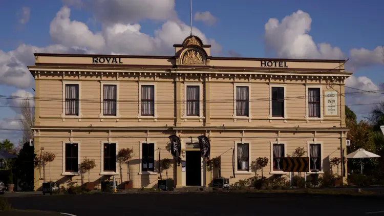 Exterior shot of a cream building reading ROYAL HOTEL
