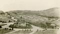 Historic sepia photograph of Karori Cemetery, with a chapel in the foreground