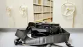 Photo of digital camera next to archive shelves