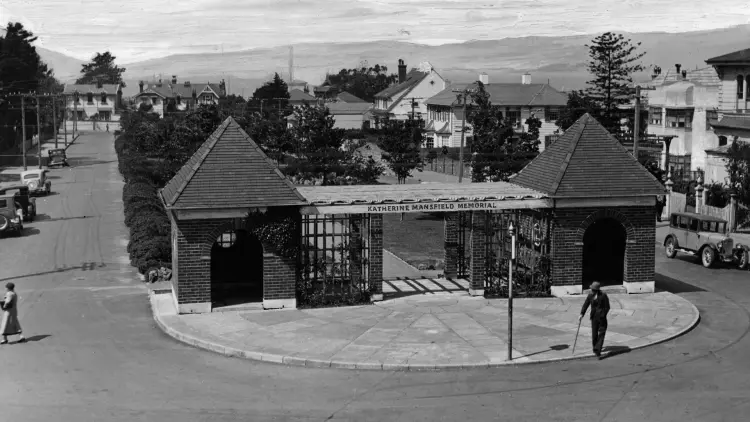 Black and white photograph of the Katherine Mansfield memorial with a person standing outside.