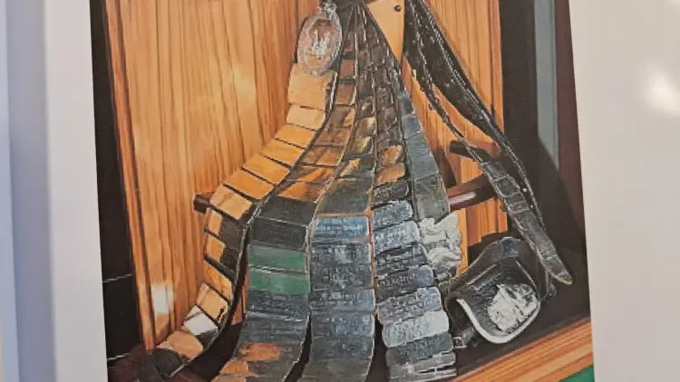 belts hanging against a wooden wall