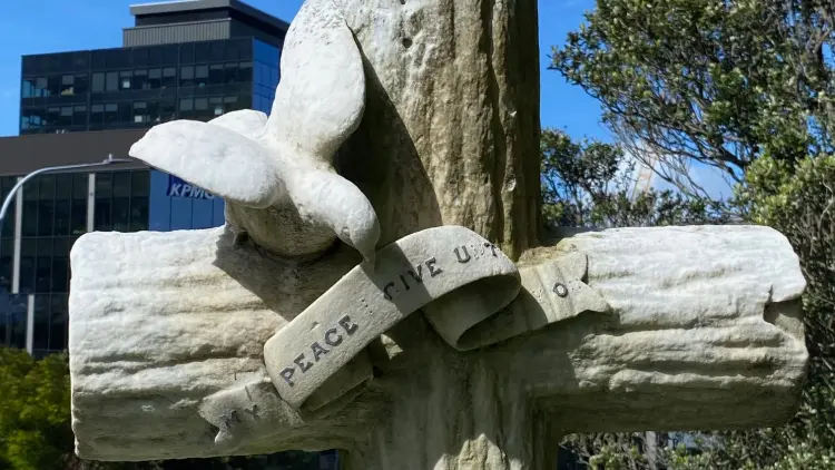 Headstone cross with stone dove
