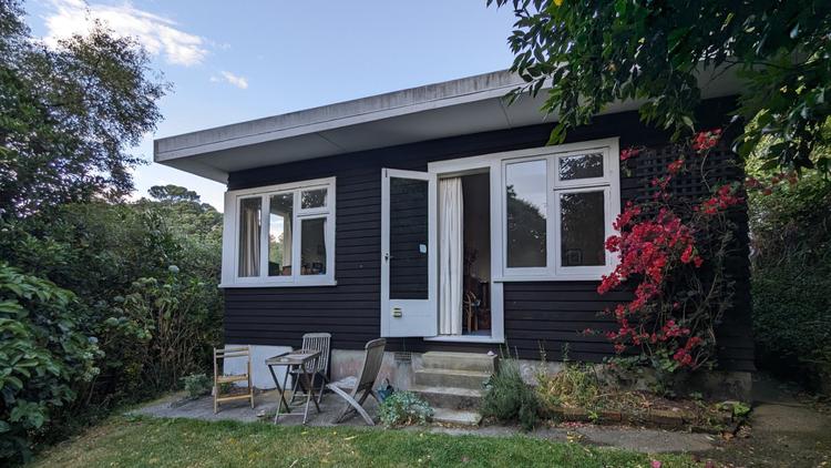 Letterbox and stone sculpture in a garden