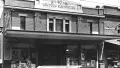 Black and white photograph of a shop