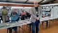 Man standing in front of tables with historical information laid out
