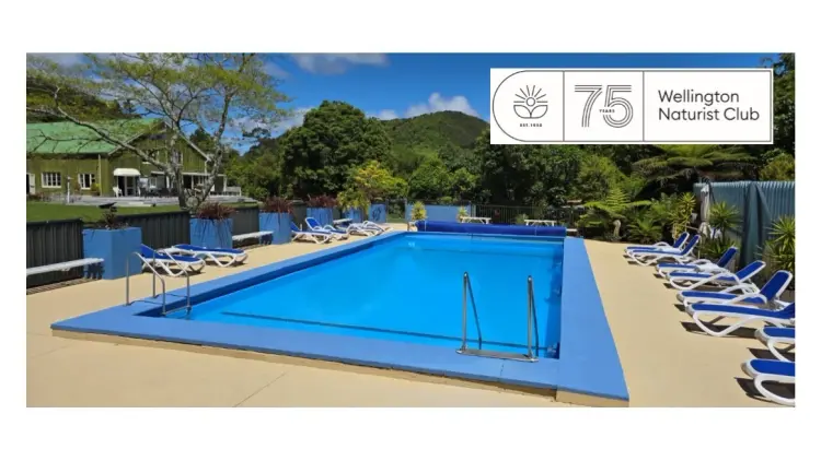 Blue swimming pool with blue chairs nearby