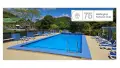 Blue swimming pool with blue chairs nearby