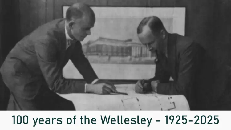 Brick hotel building and parked street cars