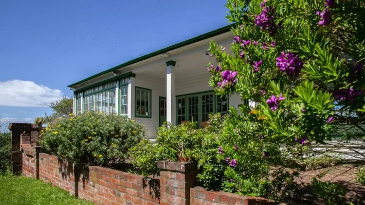 House behind a low brick wall and garden