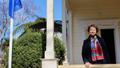 Woman standing on porch of the French Residence building