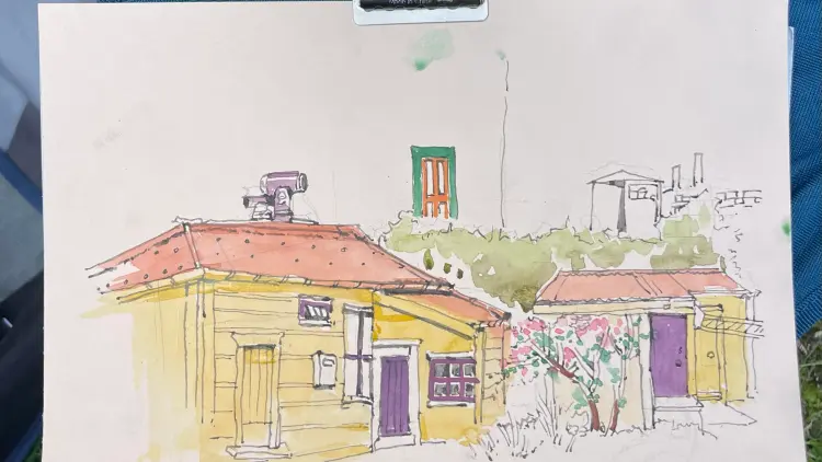 Sketch of a yellow cottage on paper