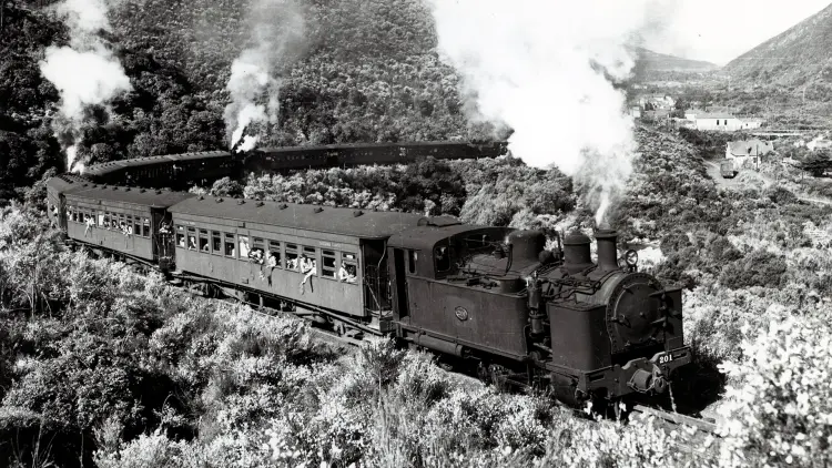 Black and white photograph of a steam train in motion