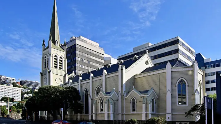 Exterior rear side shot of white and green church