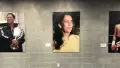 Three photographs of people mounted on a wall