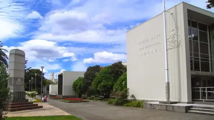 Exterior shot of a large cream coloured building.