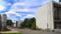 Exterior shot of a large cream coloured building.