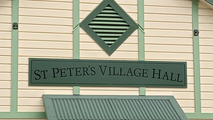 Exterior shot of building reading St Peter's Village Hall