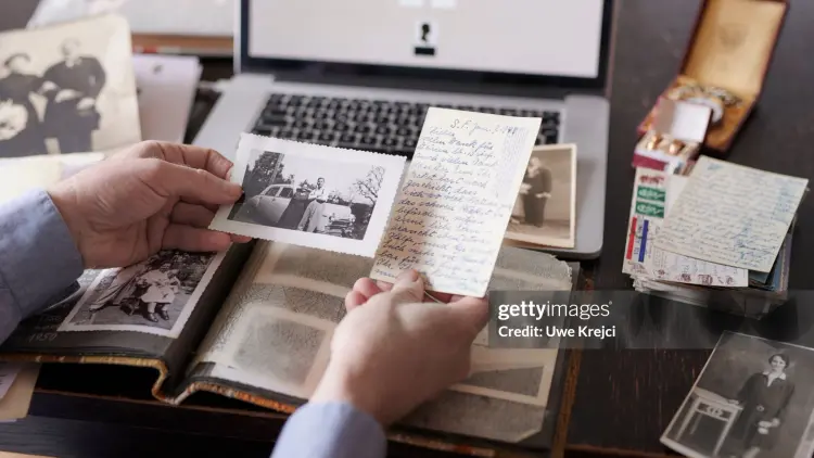 Image of table with laptop and historical photos.
