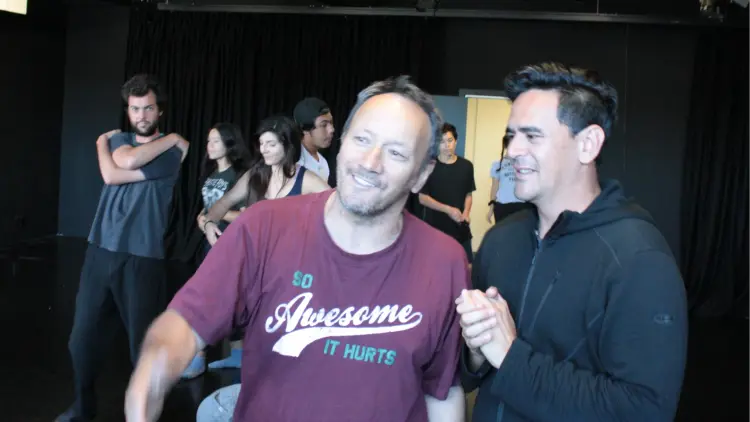 A group of people stretching and smiling