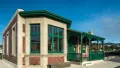 A photo of the Pukeahu Education Centre building, brick and beige cladding with emerald green window frames.