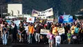 People holding colourful protest signs