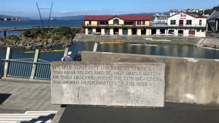 Coastal bay with buildings and a stone inscription
